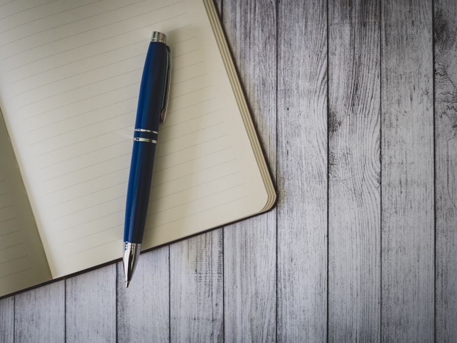 blue click pen on brown wooden table