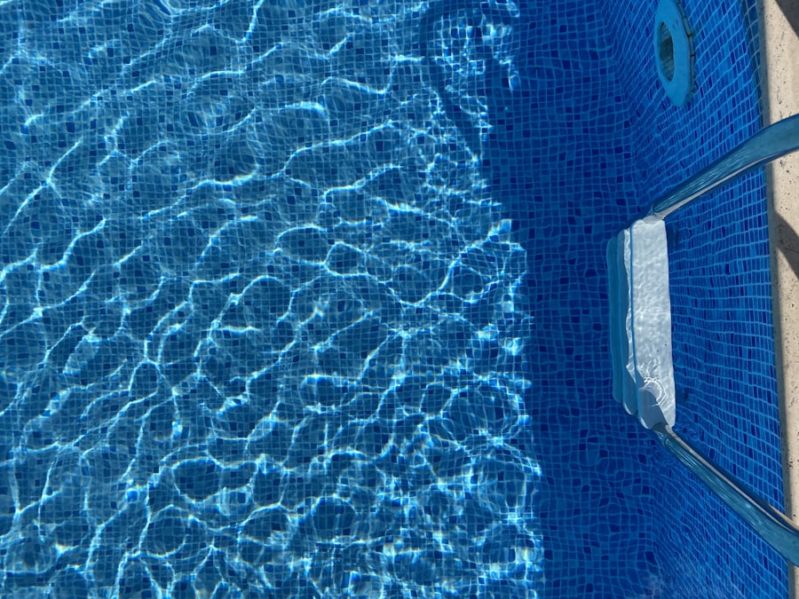 Blue mosaic tiling and coping at the edge of a pool