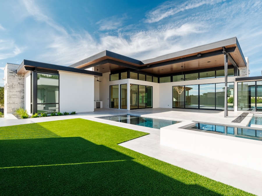 Contemporary house with swimming pool and lush green lawn