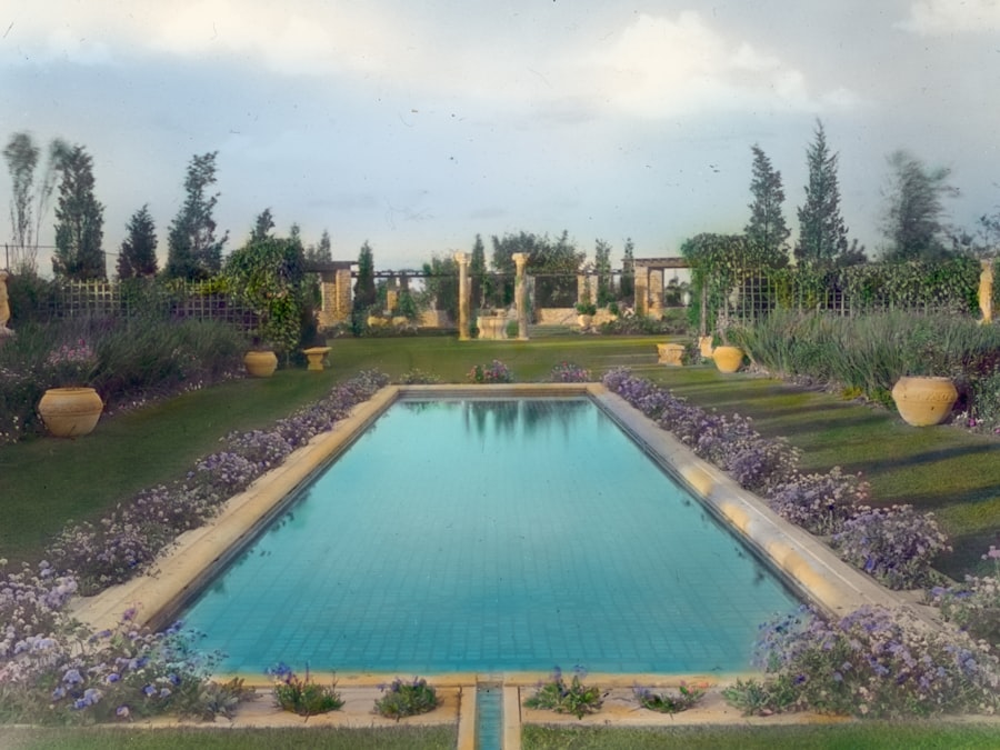A formal rectangular pool framed by lawn and deep planted borders