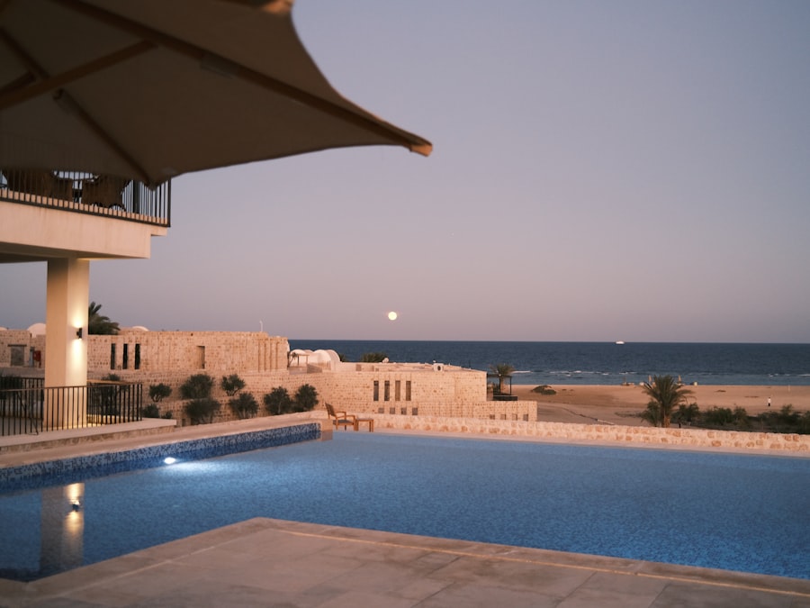 a large swimming pool next to a beach