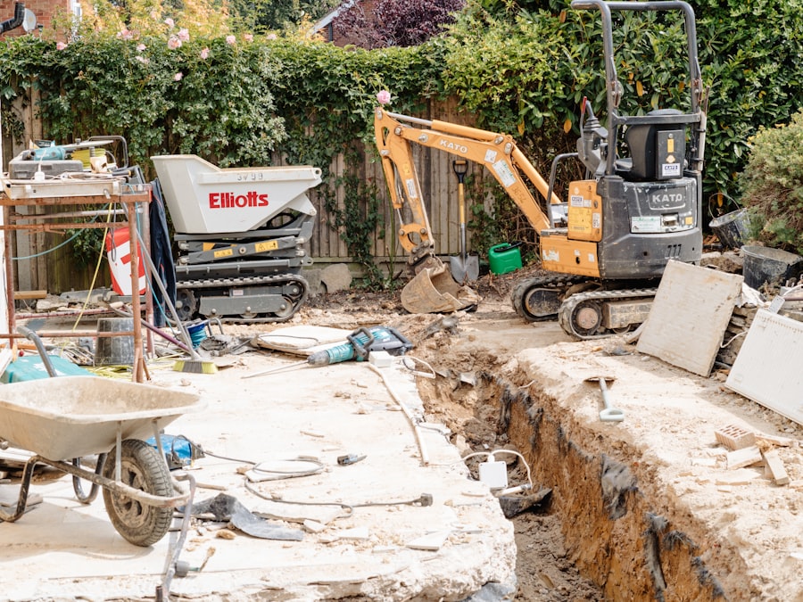 Mini excavator digging trench in backyard construction site