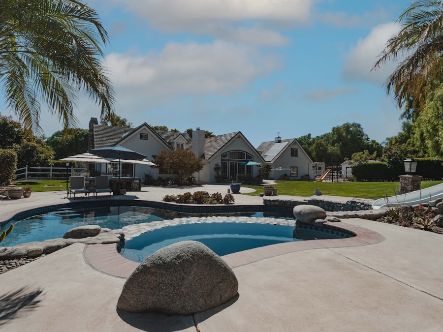 a pool surrounded by palm trees and landscaping
