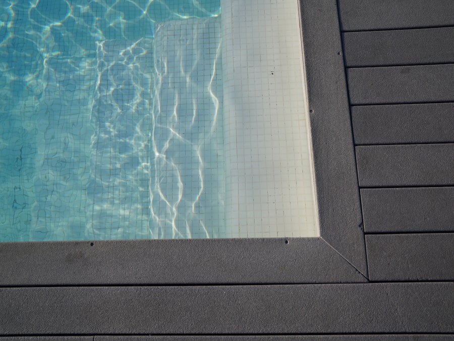 Rippling blue water in a swimming pool with deck