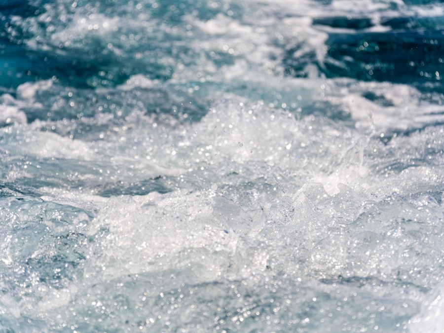 Turbulent blue water with white foam and splashes