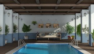Swimming pool under an old porch with a poolside sofa
