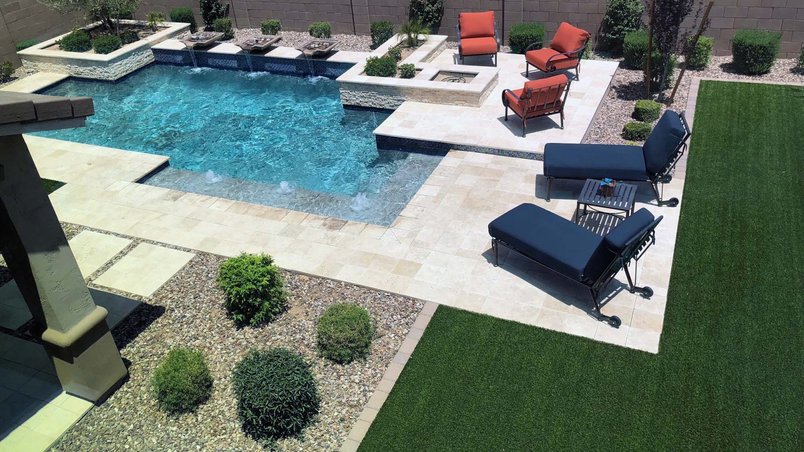 Modern pool with a lawn and lounge terrace