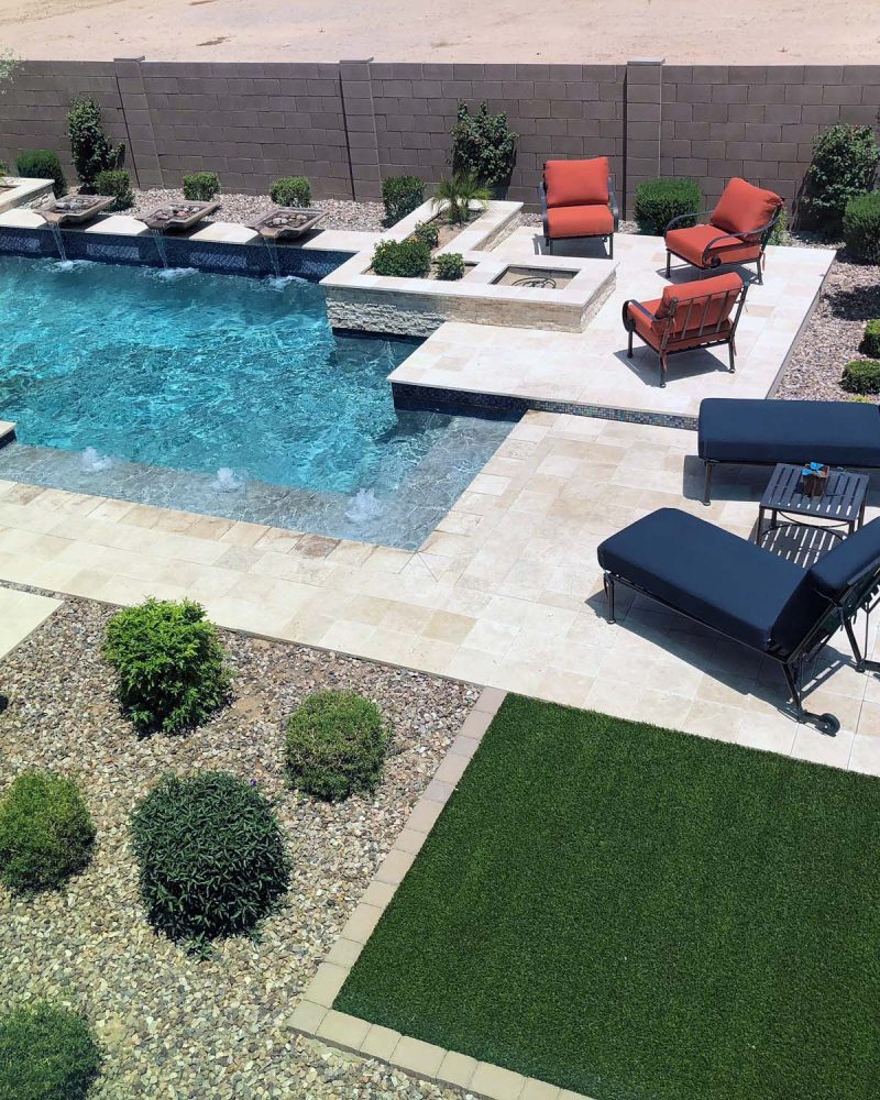 Modern pool with a lawn and lounge terrace