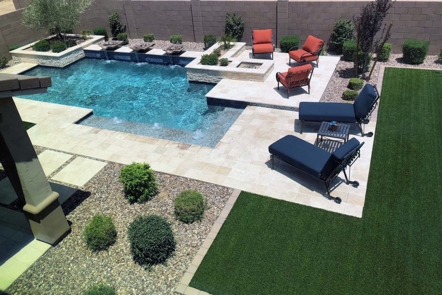 Modern pool with a lawn and lounge terrace