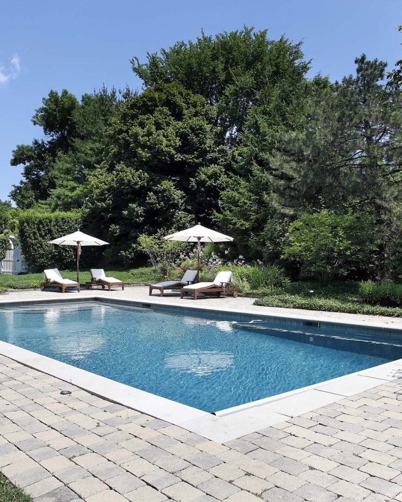 Rectangular pool with a paver deck and loungers