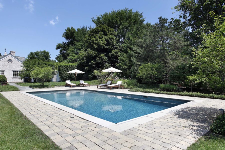 Rectangular pool with a paver deck and loungers