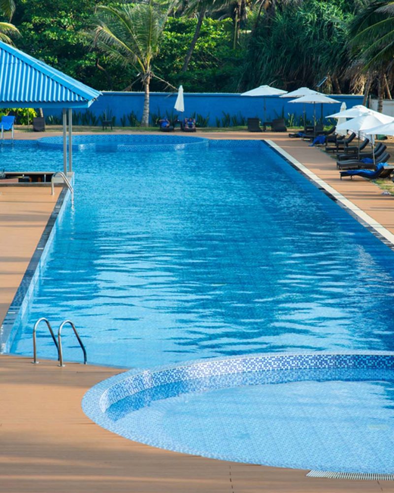 Resort-style pool with shaded loungers