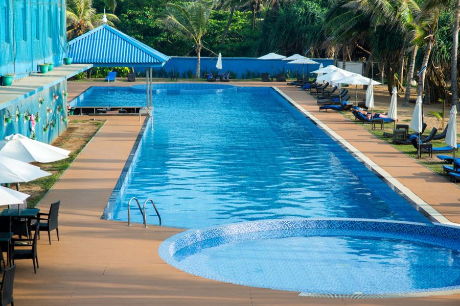 Resort-style pool with shaded loungers