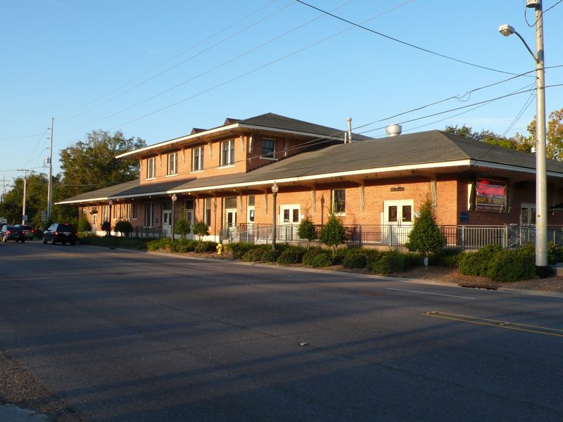 The old railway station building in Slidell, a long two-storey brick building beside the road